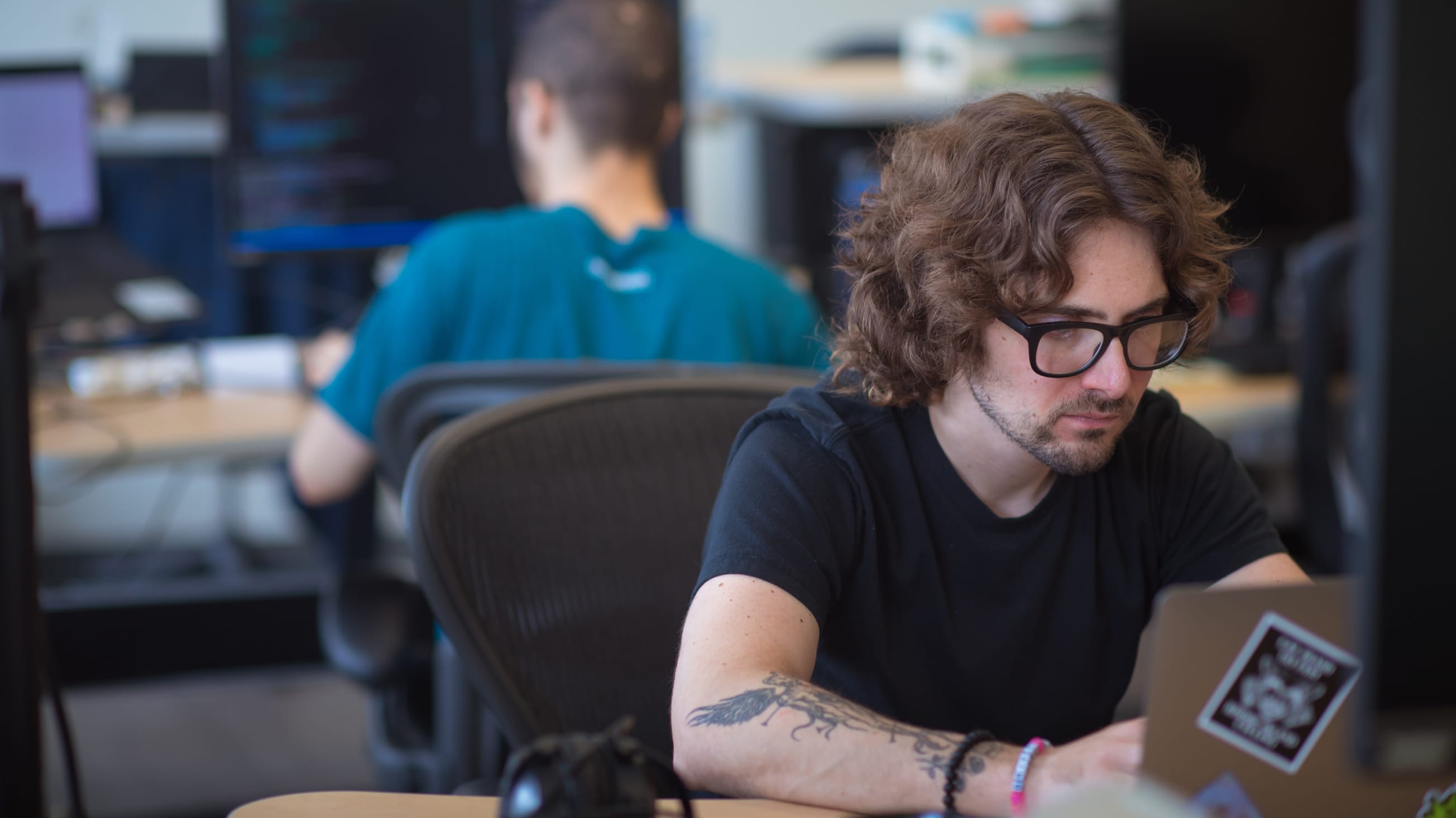 MojoTech software developer intently looks at his computer as he creates custom software.