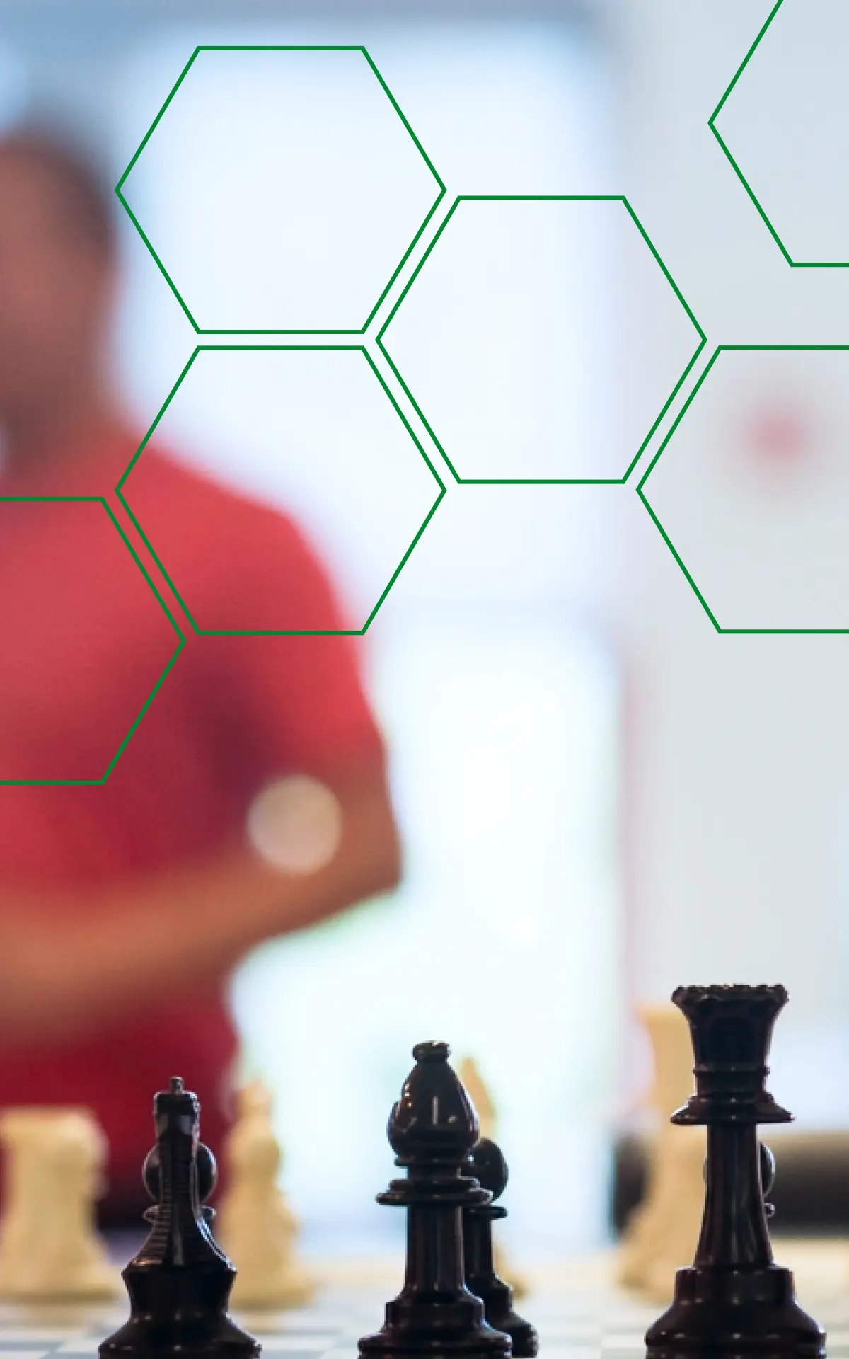 A chess board in close focus with a player seated behind it, overlaid with green hexagon outlines.